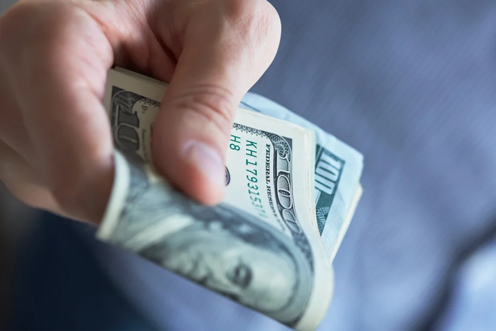 Man holding US cash in his hand