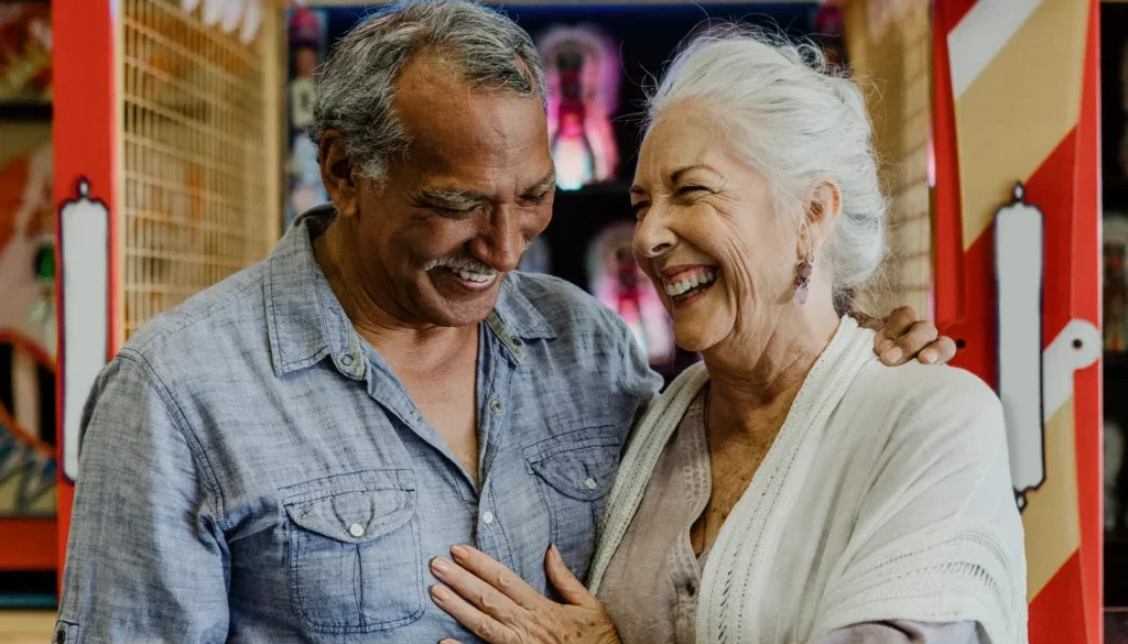 Senior couple laughing inside a game arcade