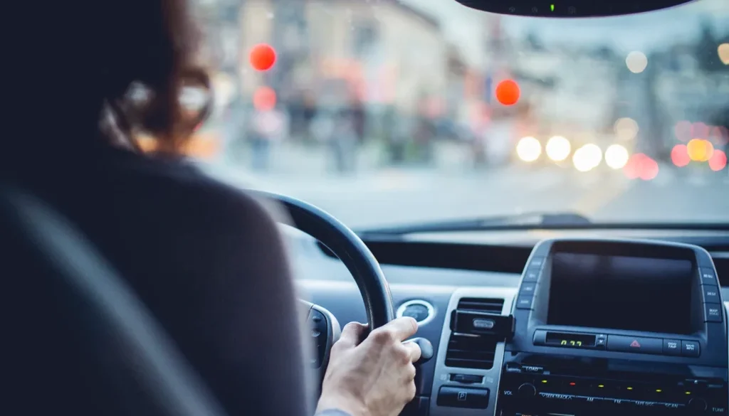 Woman driving car on city street