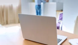 Close up laptop on table, home living room interior