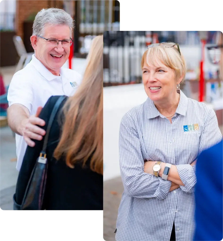 SDA CPA team members chatting with guests at an outdoor event.