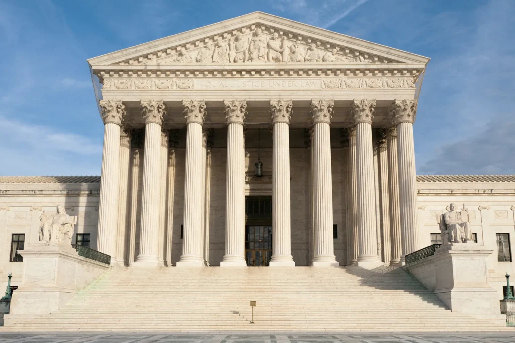 Front exterior of the U.S. Supreme Court building in Washington, D.C., with its large marble columns and steps.